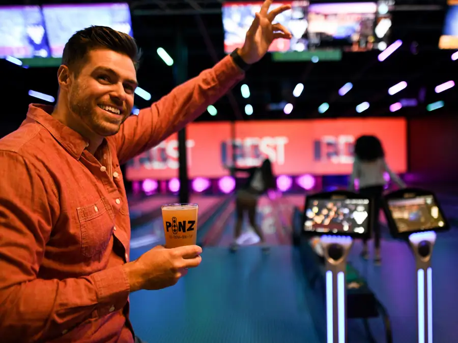 man on bolwing lanes with beer