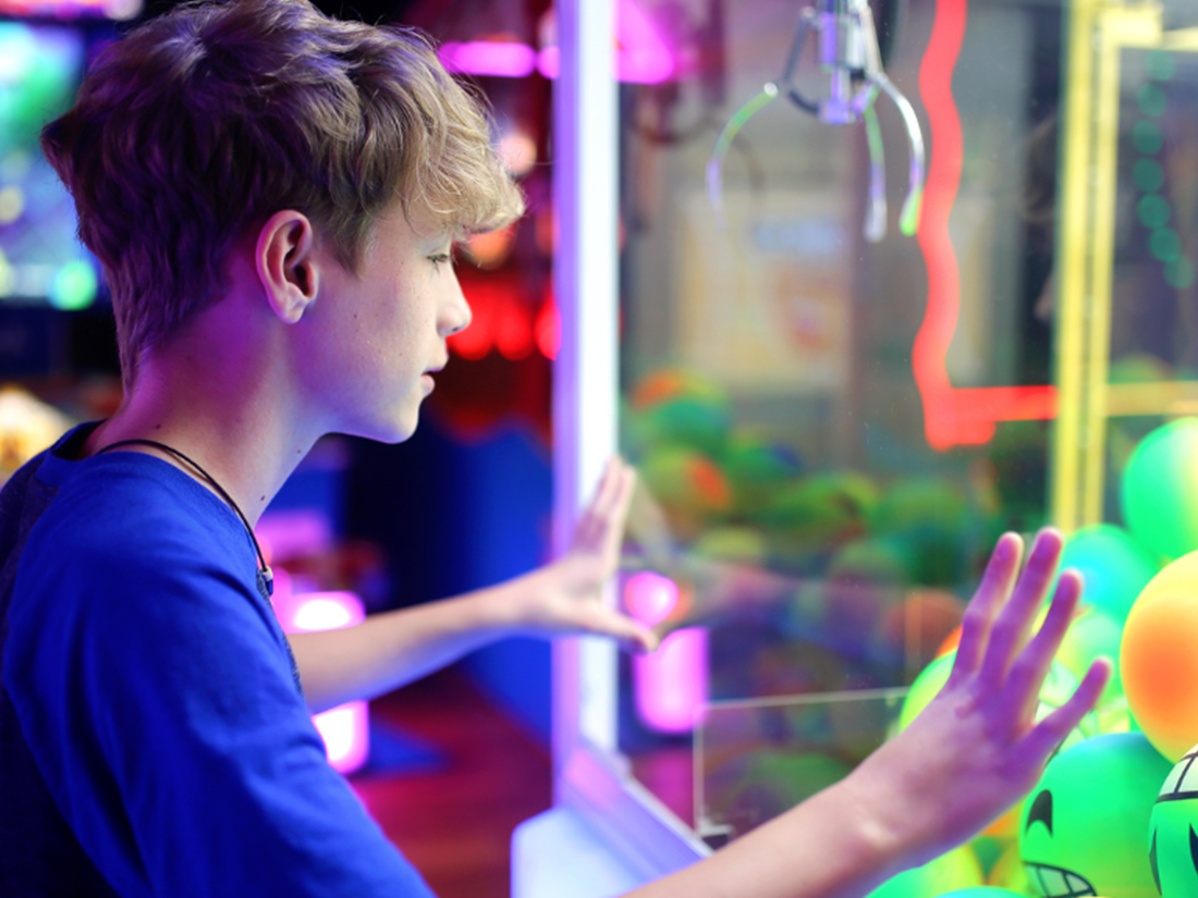 arcade kid at crane game